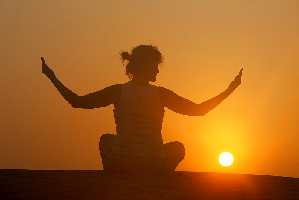 Sunset meditation in the desert, Abu Dhabi, United Arab Emirates, Middle East