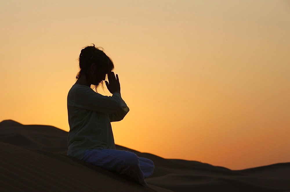 Sunset meditation in the desert, Abu Dhabi, United Arab Emirates, Middle East