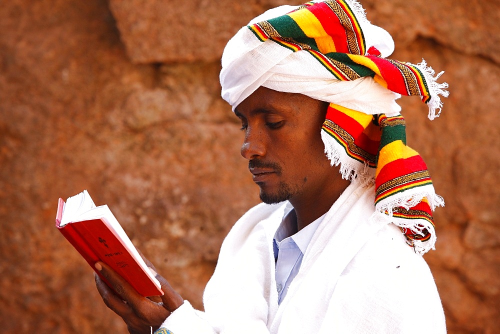 Faithful reading outside a church in Lalibela, Ethiopia, Africa