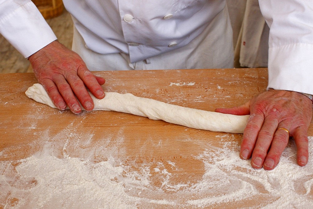 Bakers making loaves of bread (baguettes), Paris, France, Europe