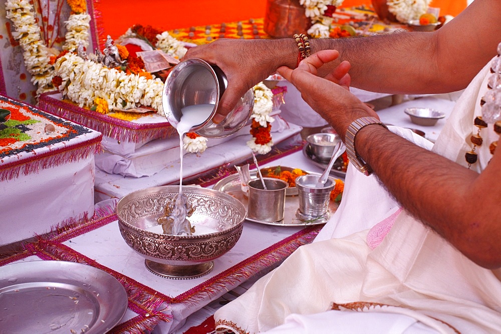 Bathing a statue of the goddess Durga with milk during Puja in a Hindu temple, Haridwar, India, Asia