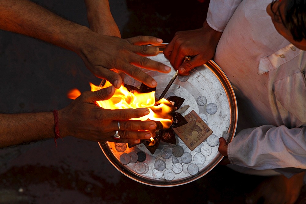 Priest and devotee performing aarti, Haridwar,Uttarakhand, India, Asia