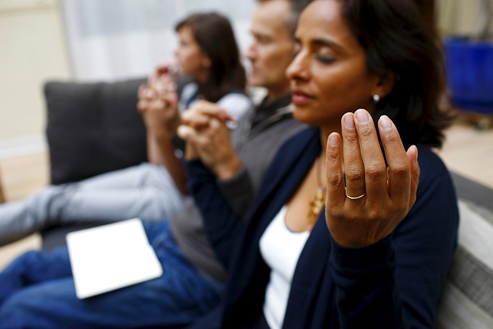 Family praying at home, Paris, France, Europe