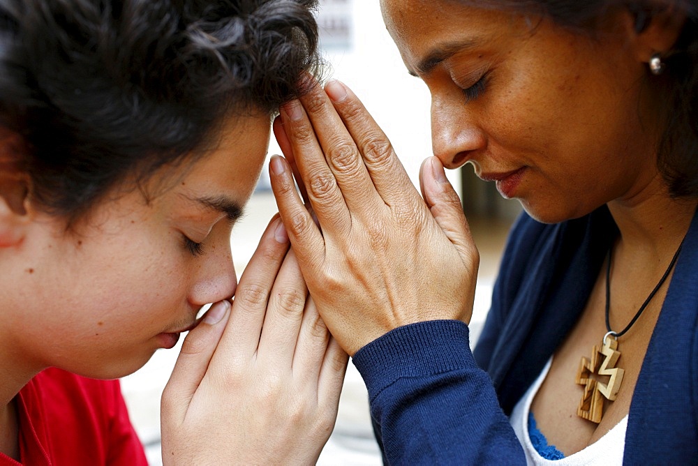 Mother and son praying at home, Paris, France, Europe