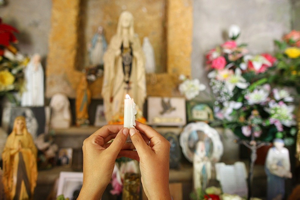 Woman praying in a chapel, Les Contamines, Haute-Savoie, France, Europe