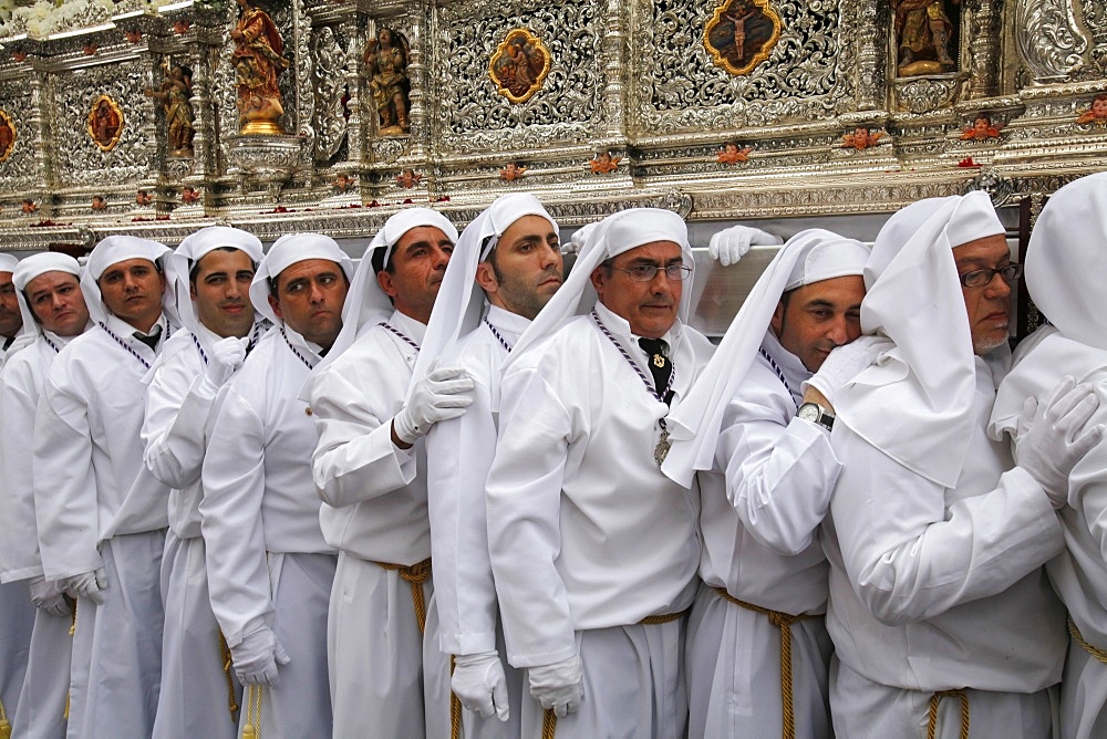 Nazarenos carrying the Rocio float during Easter week procession, Malaga, Andalucia, Spain, Europe