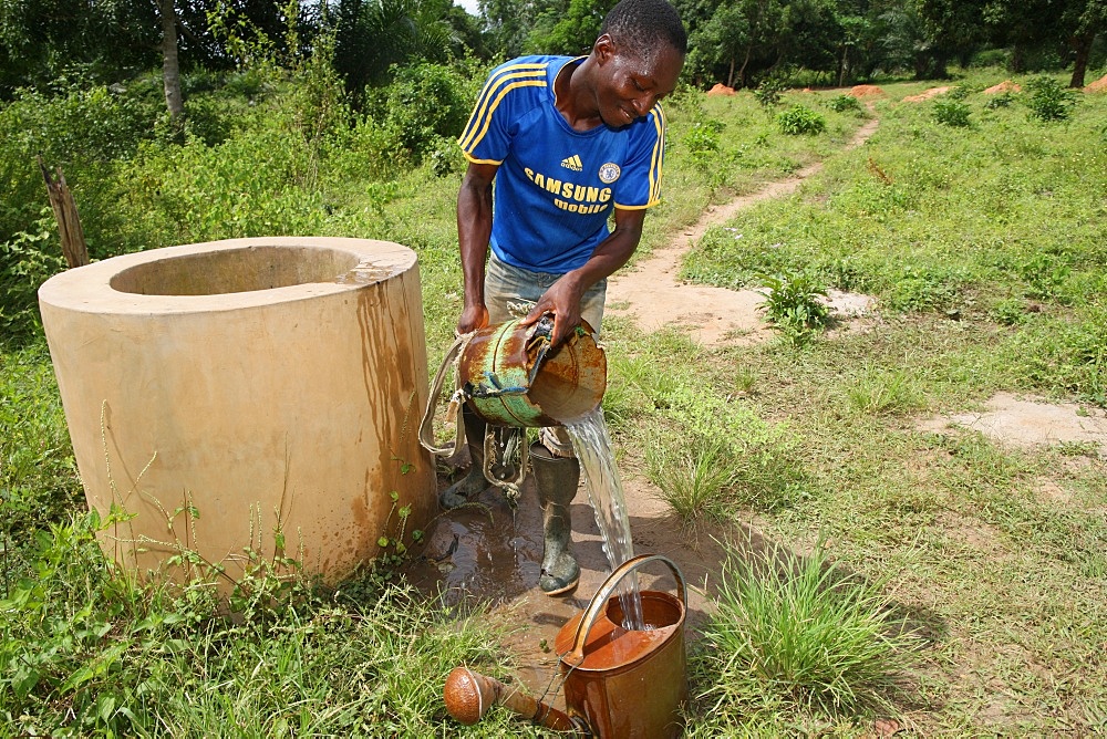 Man fetching water from well, Tori, Benin, West Africa, Africa