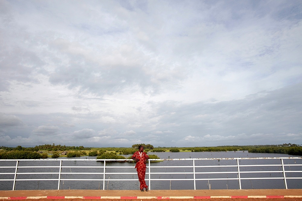 African man on a bridge, Ouidah, Benin, West Africa, Africa