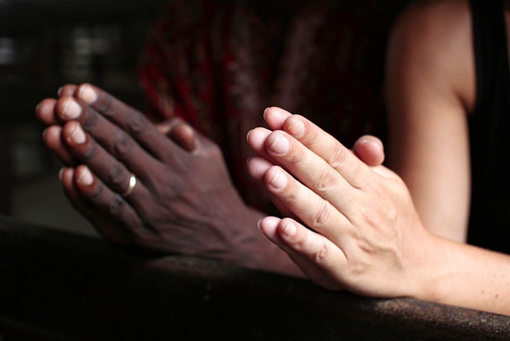 Man and woman praying together in a church, Cotonou, Benin, West Africa, Africa