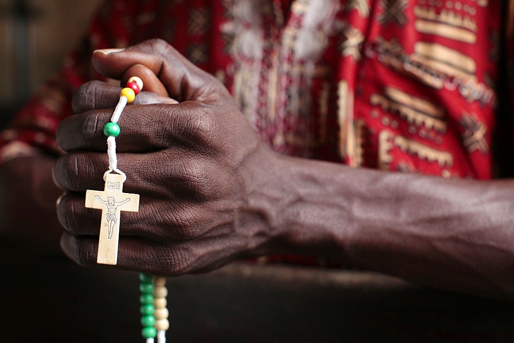 African man praying the rosary, Cotonou, Benin, West Africa, Africa