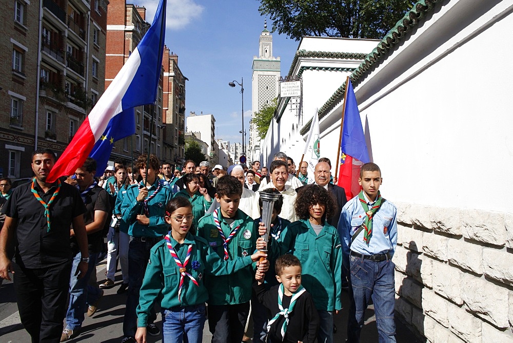 Muslim scouts carrying a torch outside the Paris Great Mosque, Paris, France, Europe