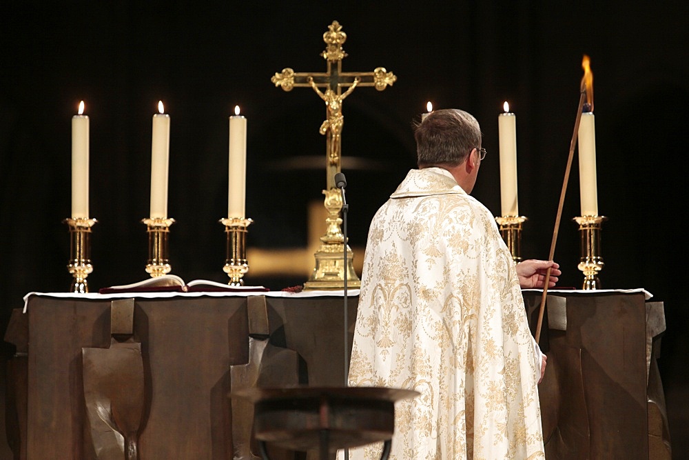 Altar candle lighting at Notre-Dame de Paris cathedral, Paris, France, Europe