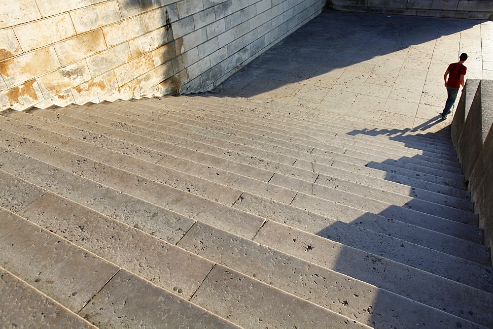 Person walking down a stone staircase, Paris, France, Europe