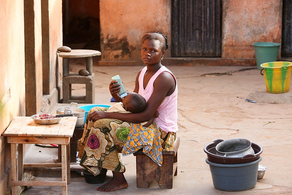 Woman feeding her baby, Lome, Togo, West Africa, Africa