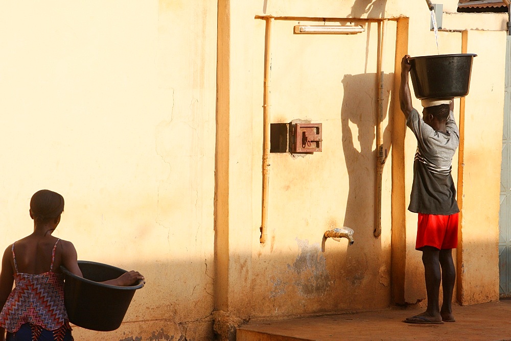 Woman carrying water, Lome, Togo, West Africa, Africa