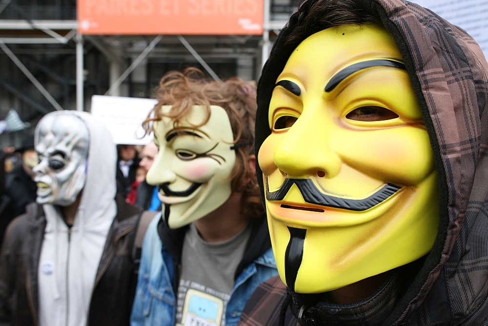 Protestors wearing Guy Fawkes masks, trademark of the Anonymous movement and based on a character in the film V for Vendetta, Paris, France, Europe