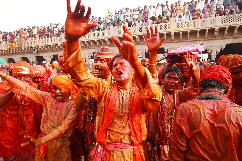 Barsana villagers celebrating Holi in Nandgaon, taunting Nandgaon villagers who throw colored fluids over them, Nandgaon, Uttar Pradesh, India, Asia