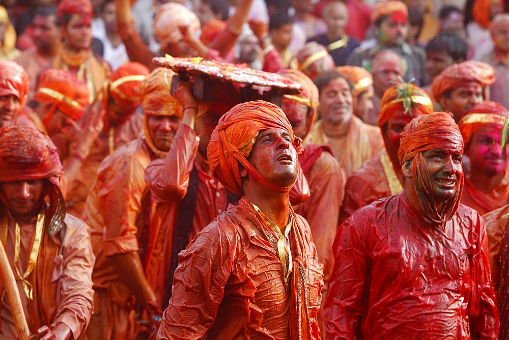 Barsana villagers celebrating Holi in Nandgaon, taunting Nandgaon villagers who throw colored fluids over them, Nandgaon, Uttar Pradesh, India, Asia