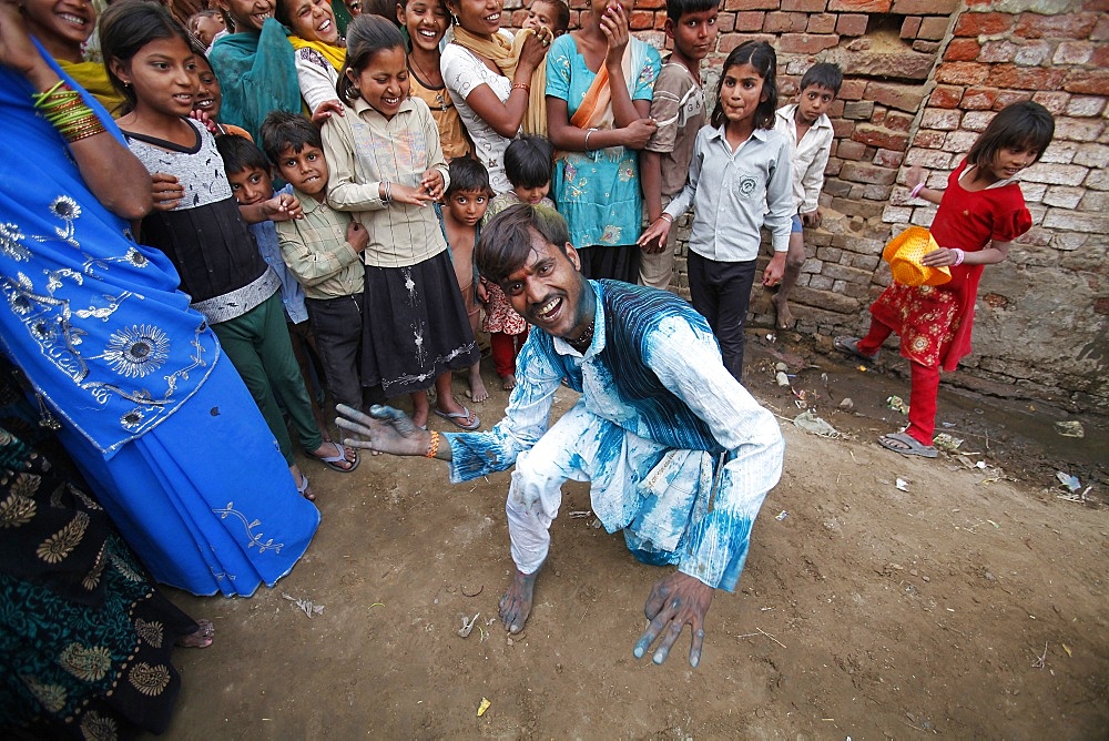 Dancing in the street during Holi celebration in Goverdan, Uttar Pradesh, India, Asia