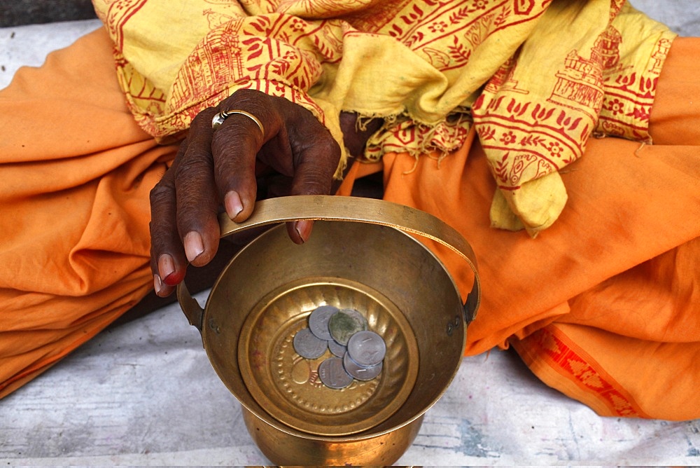 Holy man begging outside a temple, Vrindavan, Uttar Pradesh, India, Asia