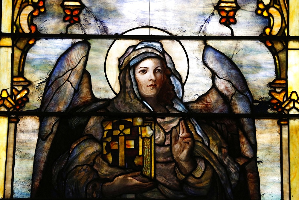 Stained glass window by Louis Comfort Tiffany showing an angel holding the Bible, called the World, The American church in Paris, France, Europe