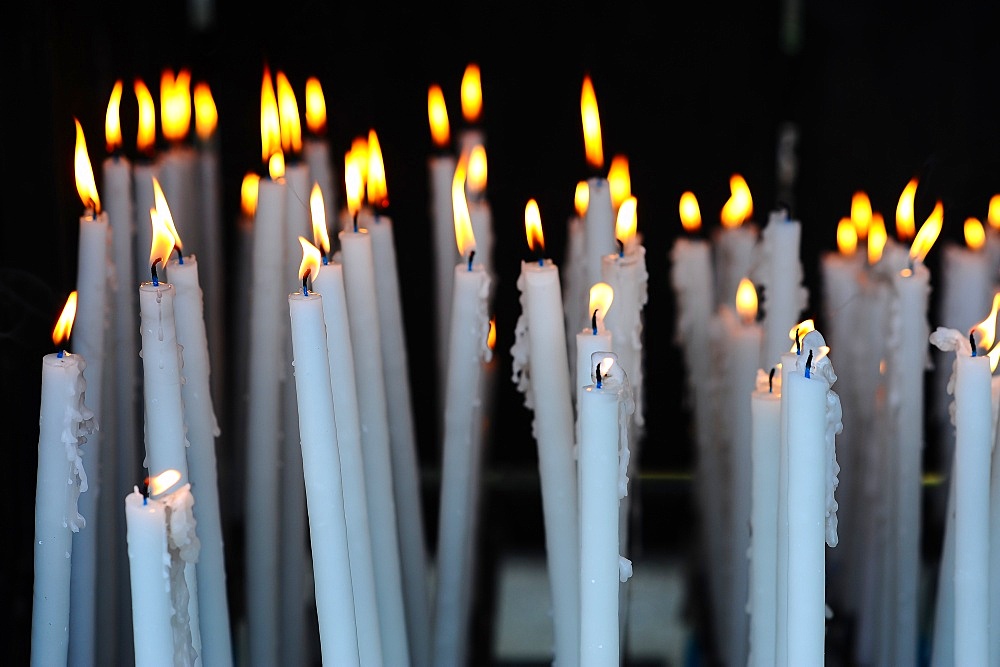 Altar candles in the Cave where Bernadette Soubirous had her Marian apparitions of our Lady of Lourdes in the French town of Lourdes, Hautes-Pyrenees, France, Europe