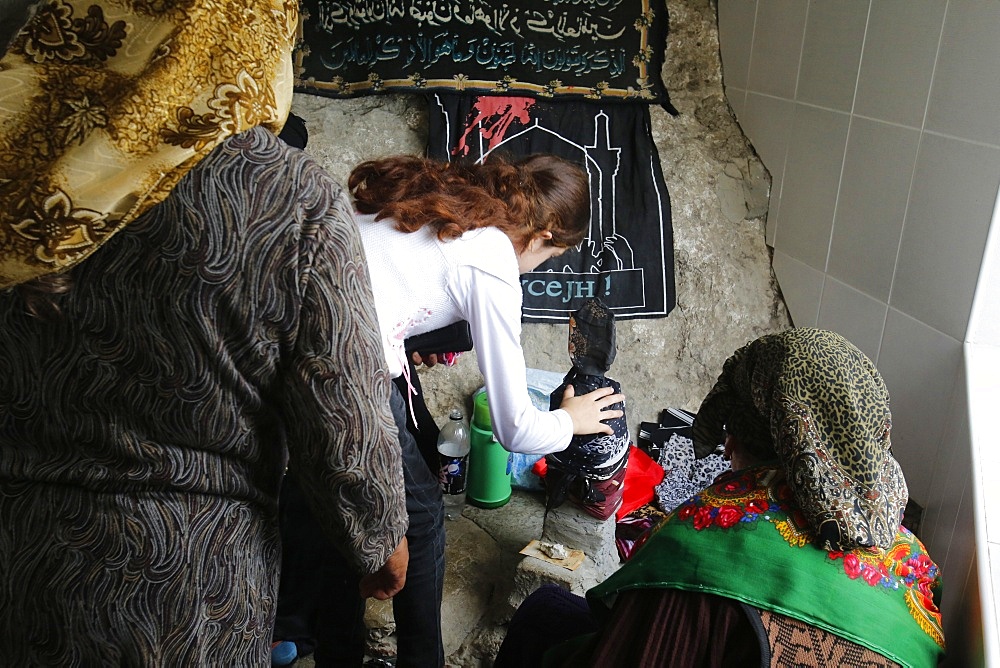 Pilgrims touching a stone in the shrine on Besh Barmaq mountain, Siyazan, Azerbaijan, Central Asia, Asia