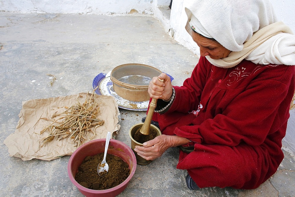 Woman grinding spices, Douz, Kebili, Tunisia, North Africa, Africa