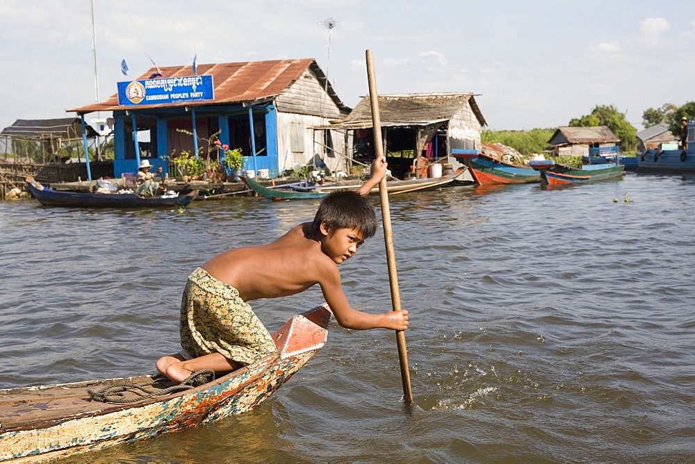 Young boy in a boat on Tonle Sap Lake, Cambodia, Indochina, Southeast Asia, Asia