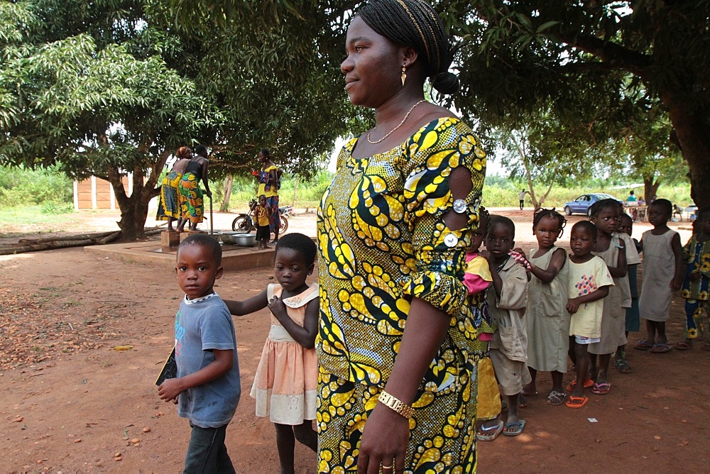 Teacher accompanying students to school, Hevie, Benin, West Africa, Africa