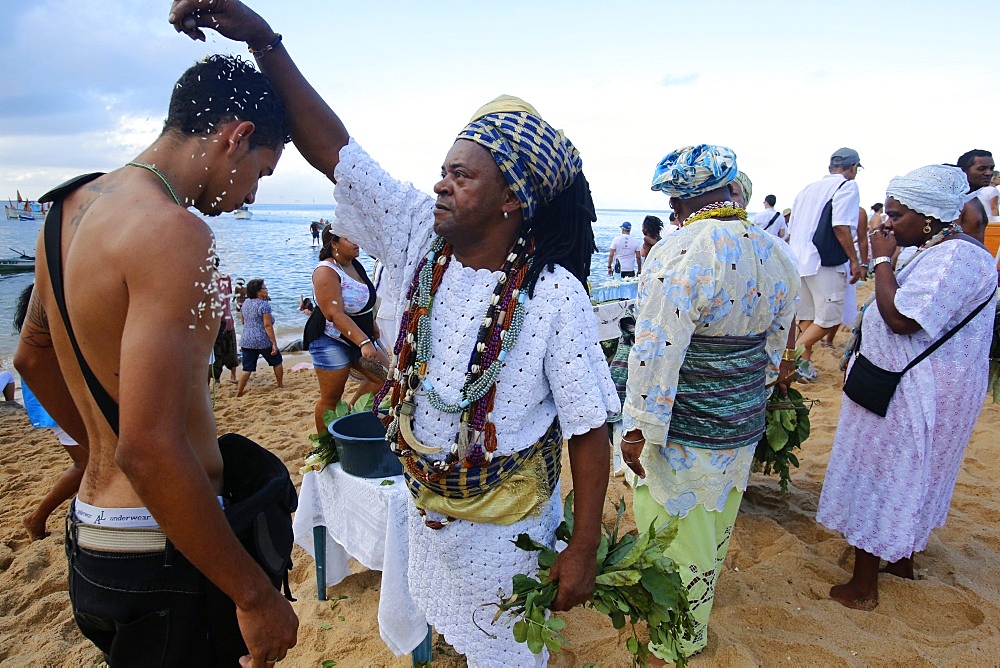 Candomble priest performing a ritual during Lemanja festival in Rio Vermelho, Salvador, Bahia, Brazil, South America