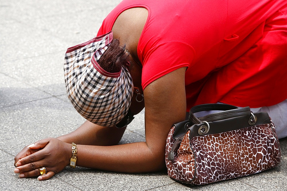 Praying woman, Lourdes, Hautes Pyrenees, France, Europe