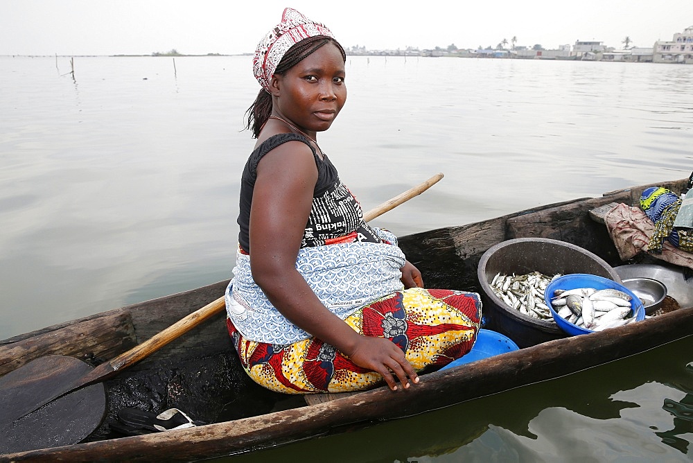 Fish seller on boat, Ayimlonfide-Ladji, Cotonou, Benin, West Africa, Africa