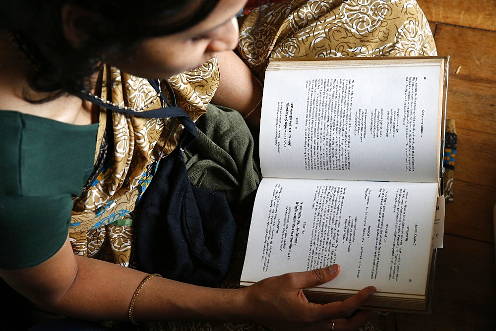 Woman reading the Bhagavad Gita, Sarcelles, Val d'Oise, France, Europe