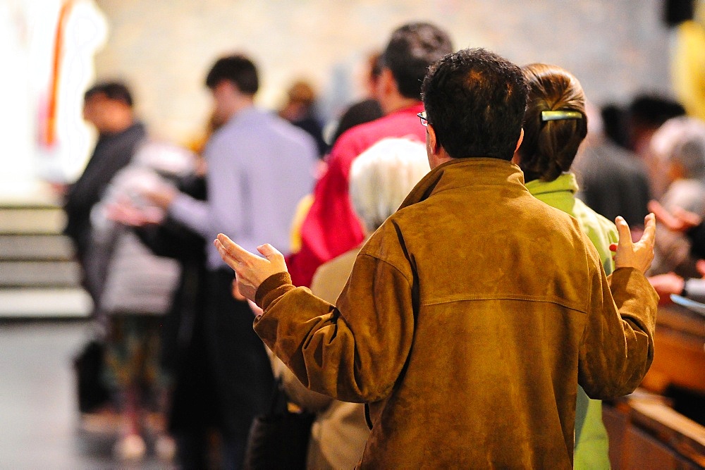 Faithfuls praying during Mass, Paris, France, Europe