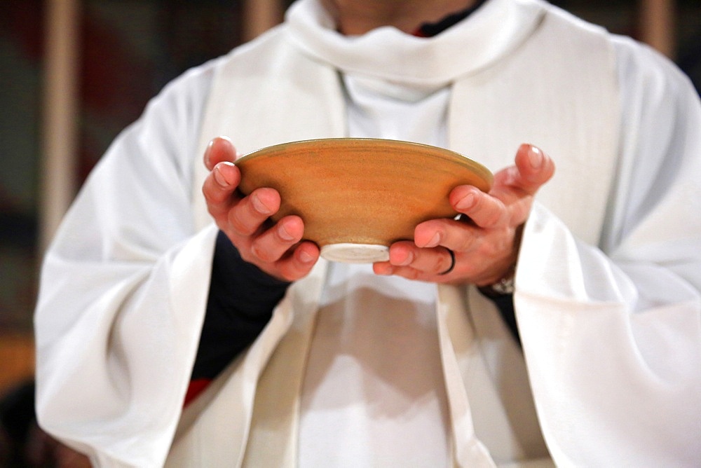 Priest holding a paten, France, Europe