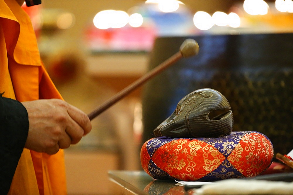 Monk playing on a wooden fish (percussion instrument), Fo Guang Shan Temple, Geneva, Switzerland, Europe