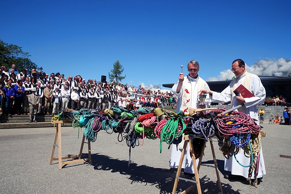 Priest blessing ice picks and ropes, Saint-Gervais traditional mountain guides festival, Saint-Gervais-les-Bains, Haute Savoie, France, Europe