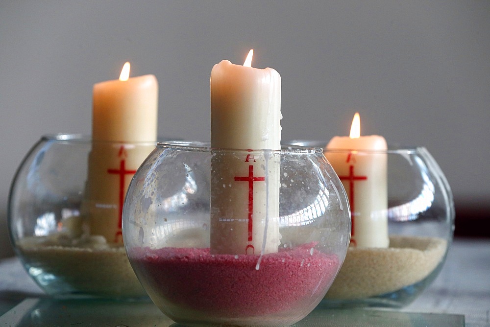 Three church candles in sand, Bussy-Saint-Georges, Seine-et-Marne, France, Europe