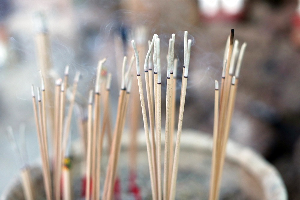 Close-up of incense sticks burning, Wat Si Muang (Simuong) Buddhist temple, Vientiane, Laos, Indochina, Southeast Asia, Asia