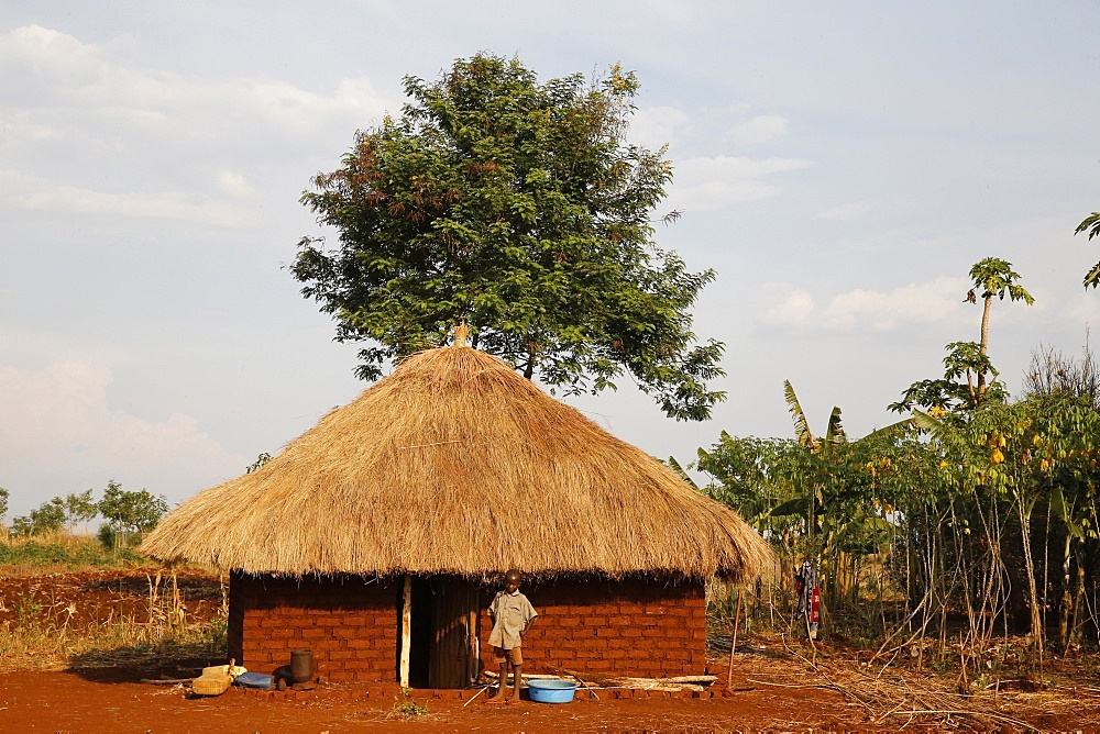 Ugandan child outside his home, Bweyale, Uganda, Africa