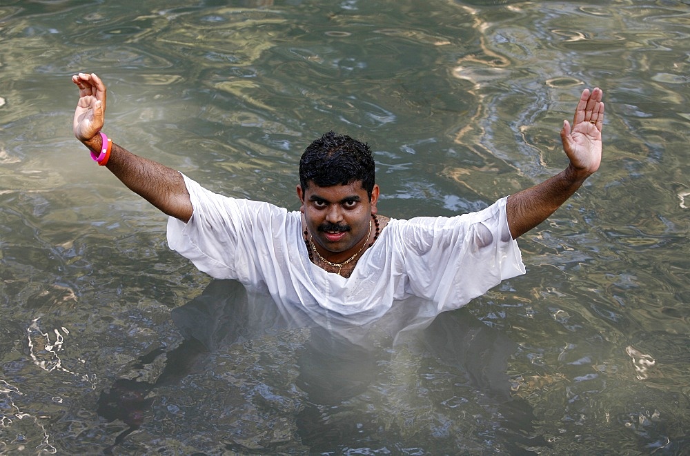 Indian pilgrim in Jordan River, Yardenit, Israel, Middle East