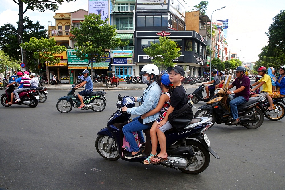 Mother and children on motor scooter on Saigon Street, Ho Chi Minh City, Vietnam, Indochina, Southeast Asia, Asia