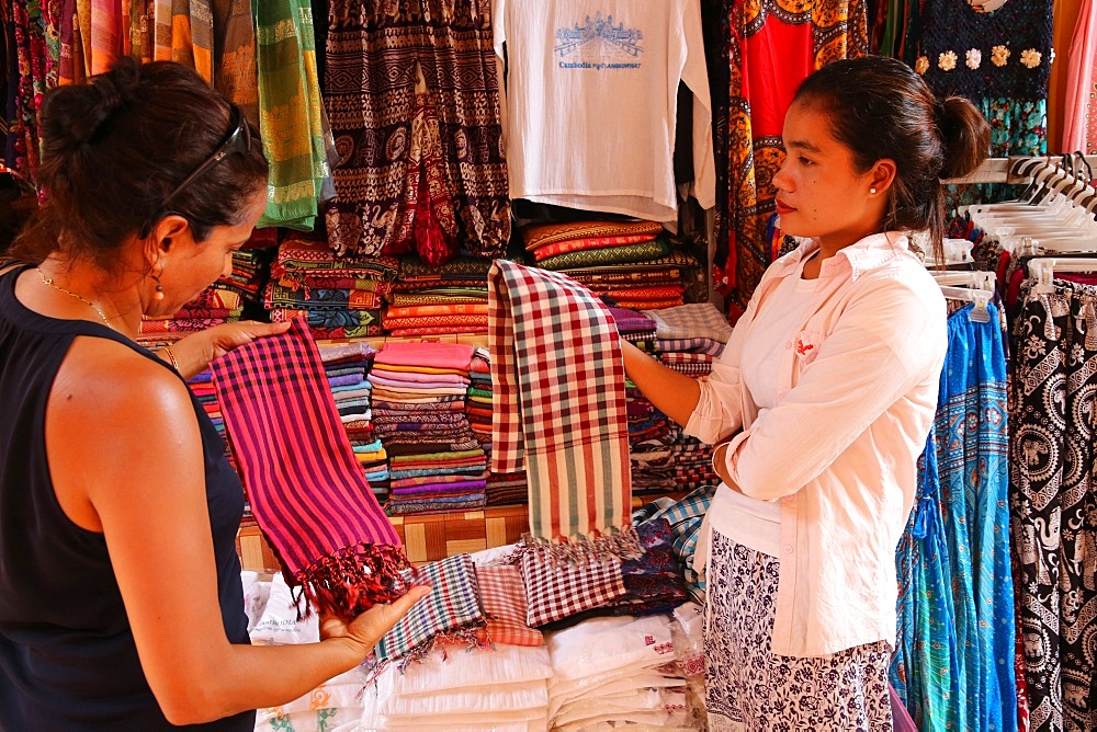 Woman buying scarves at Siem Reap market, Cambodia, Indochina, Southeast Asia, Asia