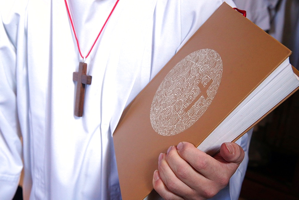 Altar boy with Holy Bible during Catholic Mass, Haute-Savoie, France, Europe