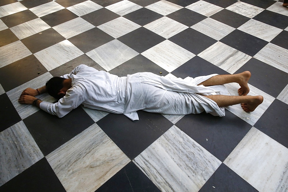 Hindu devotee prostrating at Krishna-Balaram temple, Vrindavan, Uttar Pradesh, India, Asia