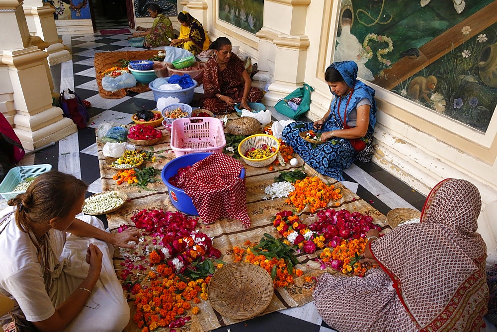 Devotees making garlands at Krishna-Balaram Hindu temple, Vrindavan, Uttar Pradesh, India, Asia