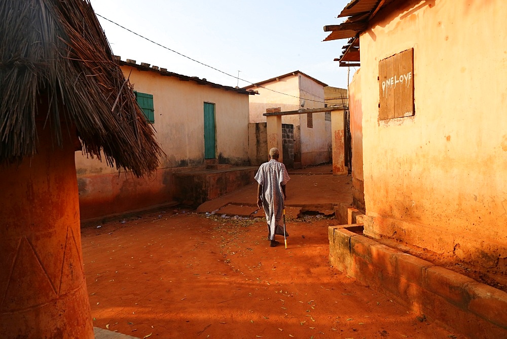 Old man walking in Togoville at sunset, Togoville, Togo, West Africa, Africa