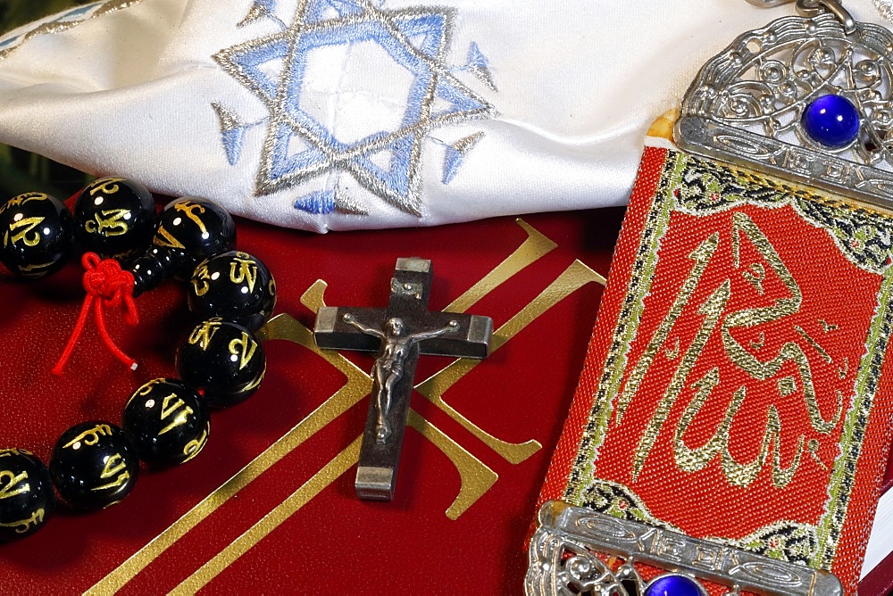 Christianity, Buddhism, Islam and Judaism, interfaith symbols of Bible, crucifix, Kippah, Allah monogram and Mala, Haute-Savoie, France, Europe