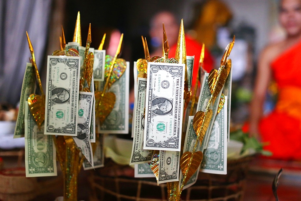 US dollars on Buddhist money tree to make merit and donate to local temple, Wat Naxai Buddhist Temple, Vientiane, Laos, Indochina, Southeast Asia, Asia